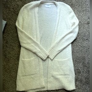 Long, white cardigan.